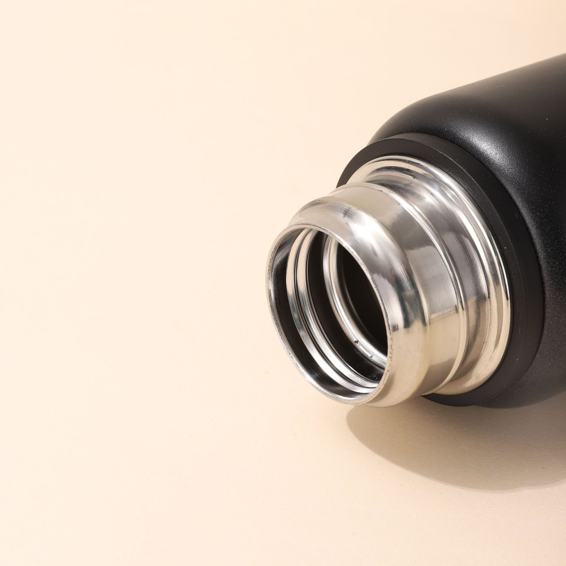Close-up of thermos stainless steel bottle lid and mouth design