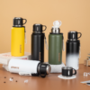 Thermos stainless steel bottles in all colours — green, yellow, gradient, black, and white, displayed together