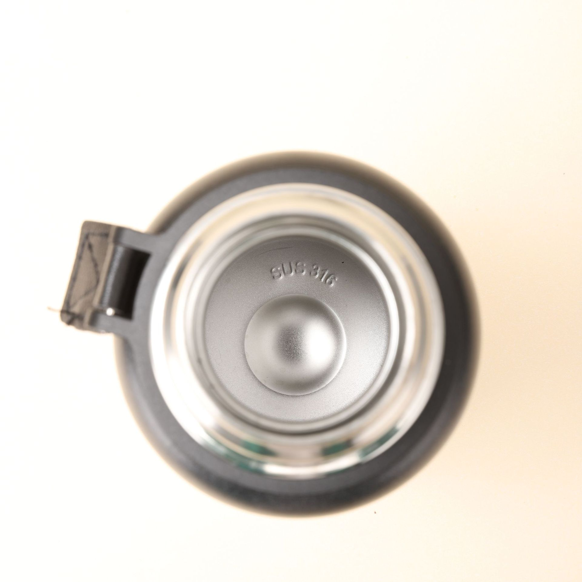 Inside view of thermos stainless steel bottle showing double-wall insulation