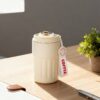 Smart coffee cup with LED temperature indicator on lid