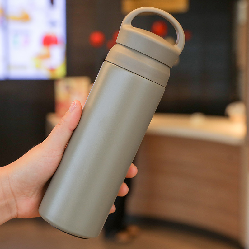 Grey stainless steel thermos bottle with matte texture