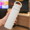 White stainless steel thermos bottle with minimalistic design